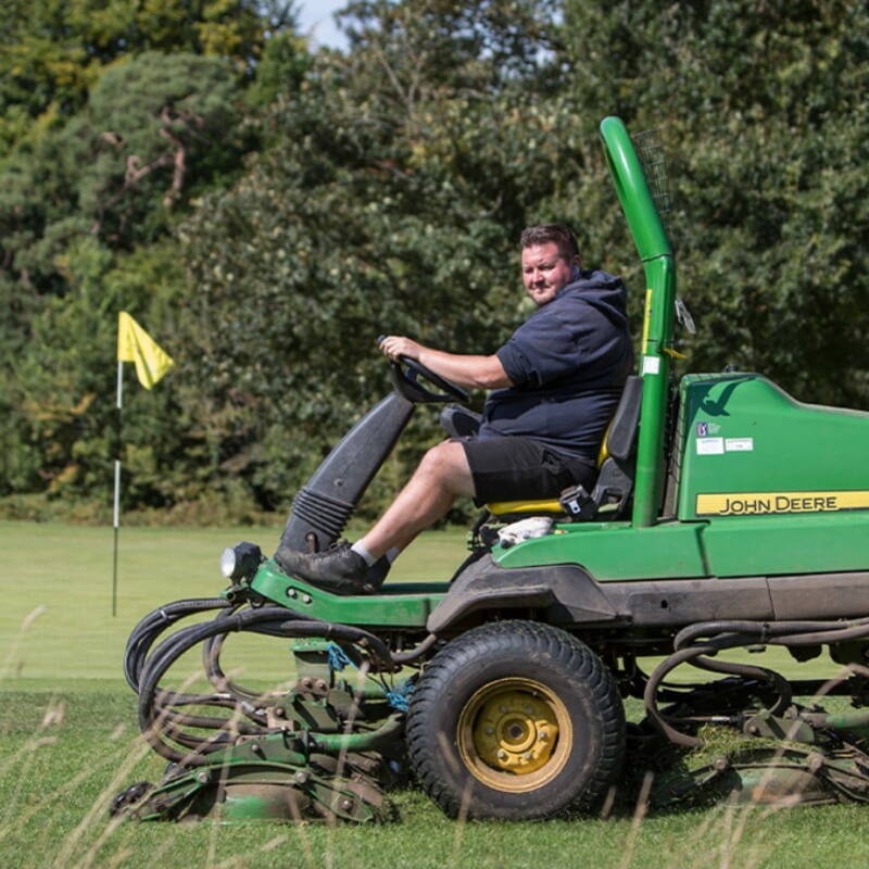 Greenkeeper on a mower